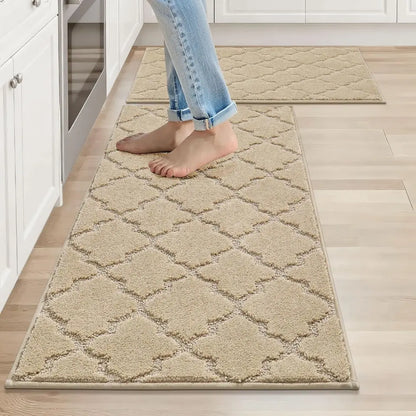 Person walking on a patterned beige rug in a kitchen.