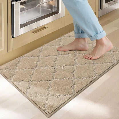 Person stepping onto a textured beige mat in a kitchen.
