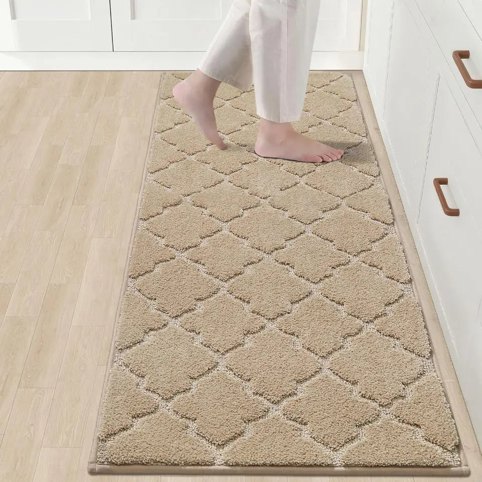 Beige diamond-patterned rug on a wooden floor with a person stepping onto it.