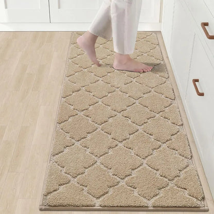 Beige diamond-patterned rug on a wooden floor with a person stepping onto it.