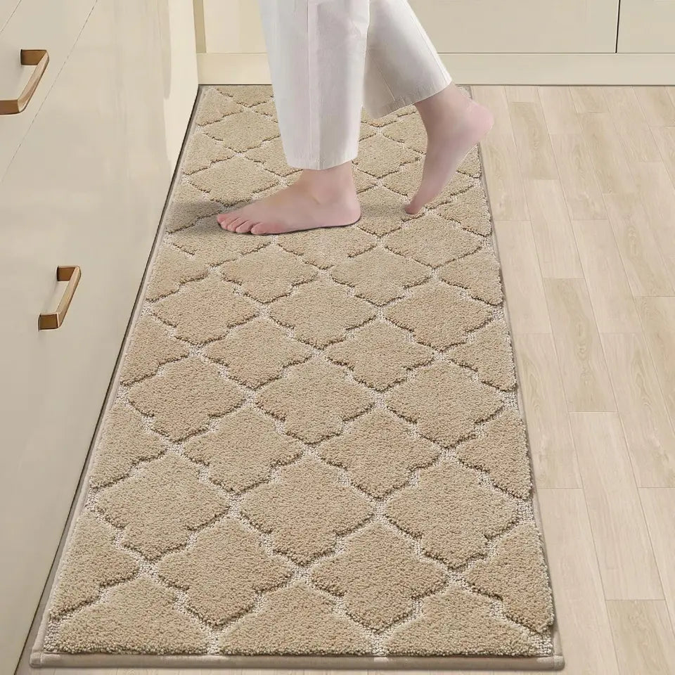 Beige diamond-patterned rug on a wooden floor with a person stepping onto it.