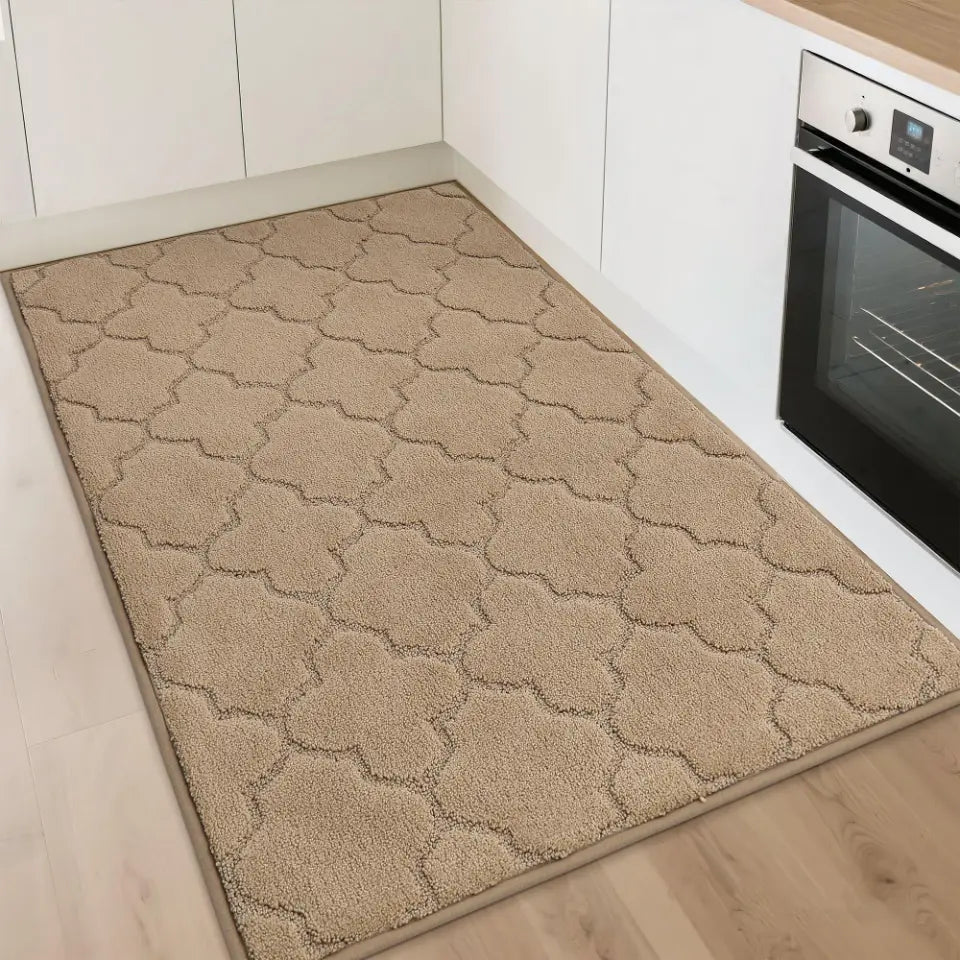 Beige patterned rug on a kitchen floor with an oven