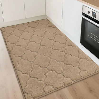 Beige patterned rug on a kitchen floor with an oven