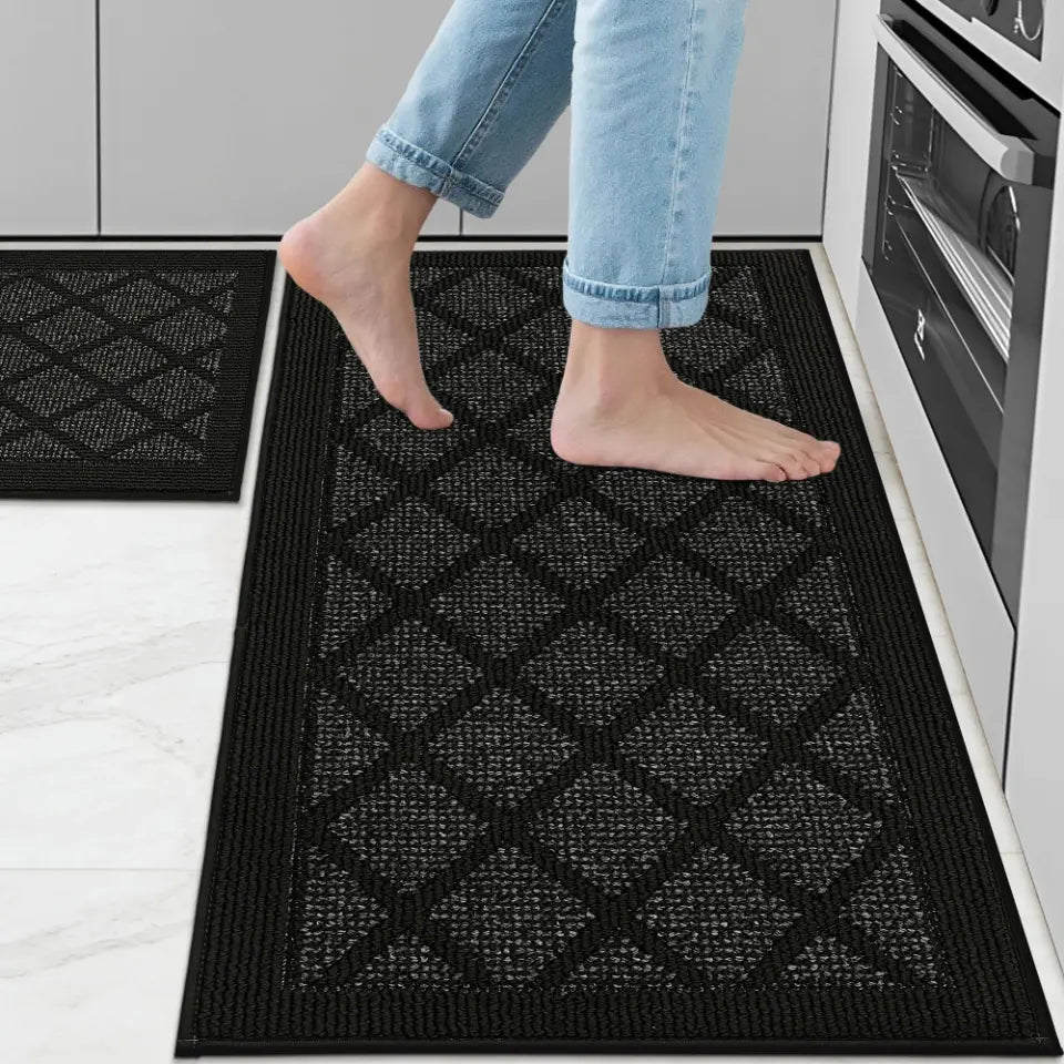Person stepping onto a black textured mat in a kitchen setting