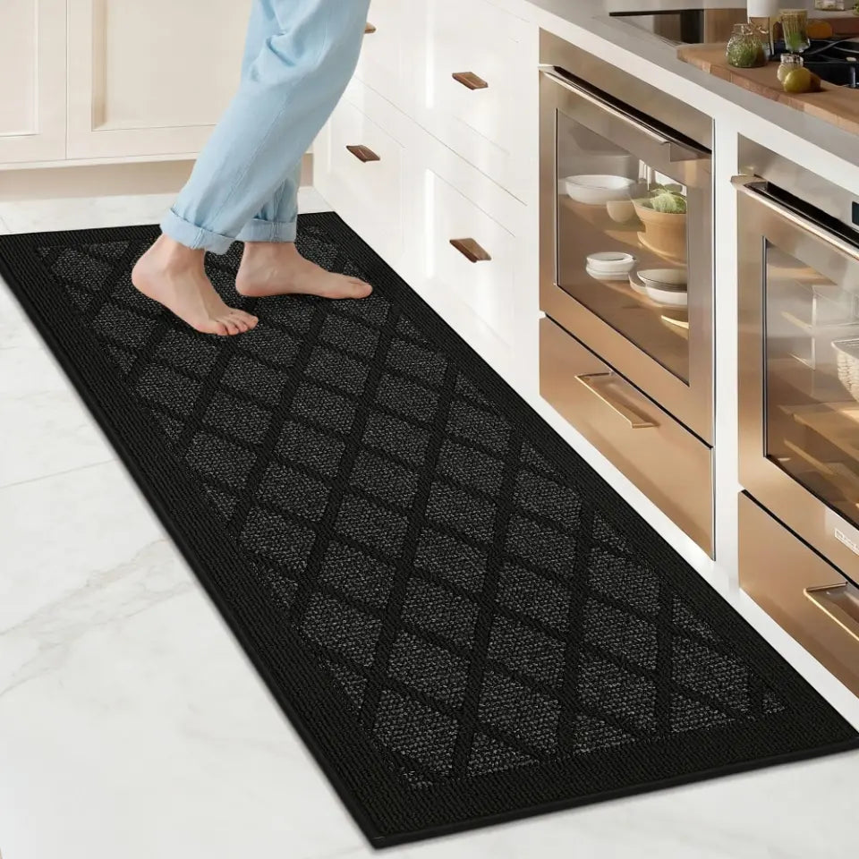 Person stepping onto a black textured mat in a kitchen.