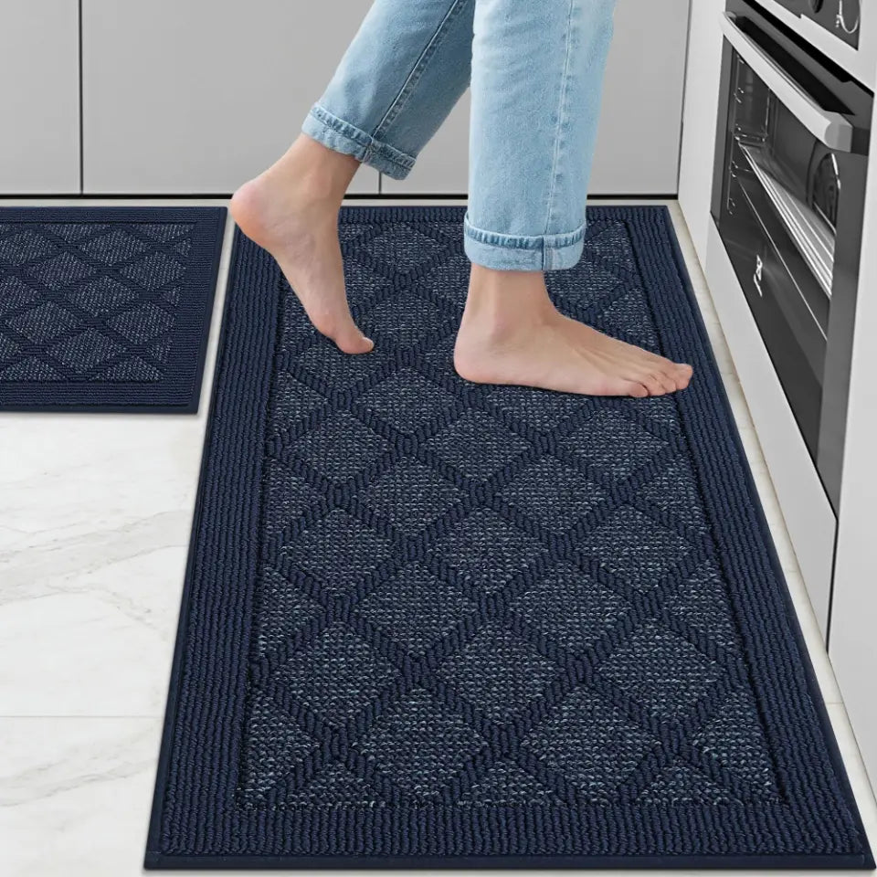 Person stepping onto a navy blue textured mat in a kitchen.