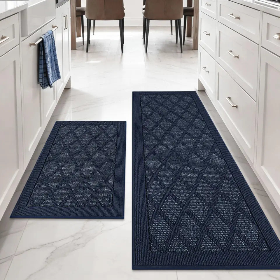 Two blue patterned mats on a white floor with kitchen cabinets and chairs in the background.