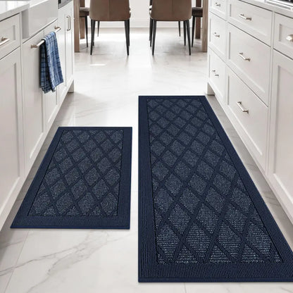 Two blue patterned mats on a white floor with kitchen cabinets and chairs in the background.