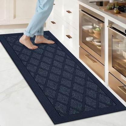 Person stepping onto a navy blue textured mat in a kitchen.