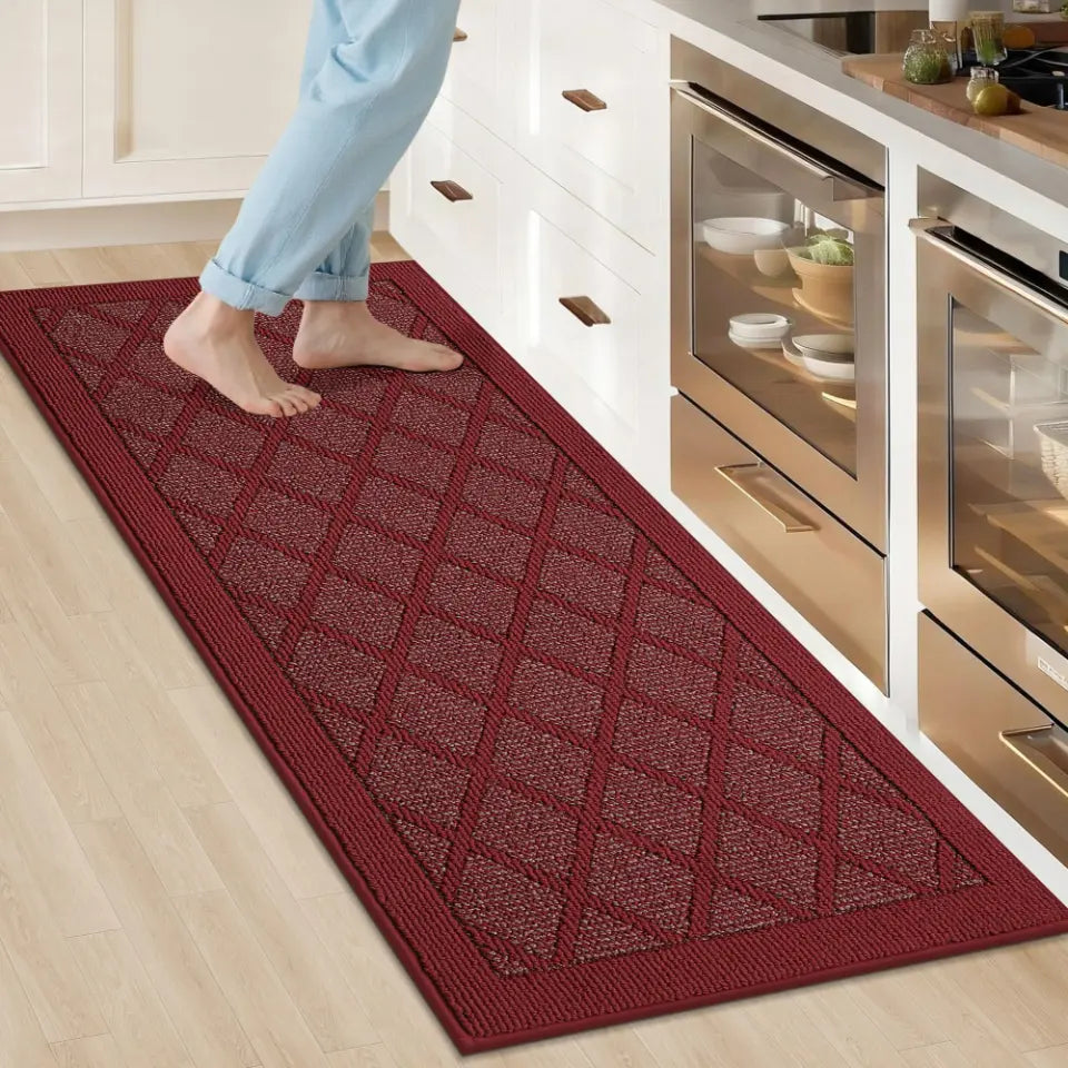 Red diamond-patterned rug on a kitchen floor with a person stepping onto it.